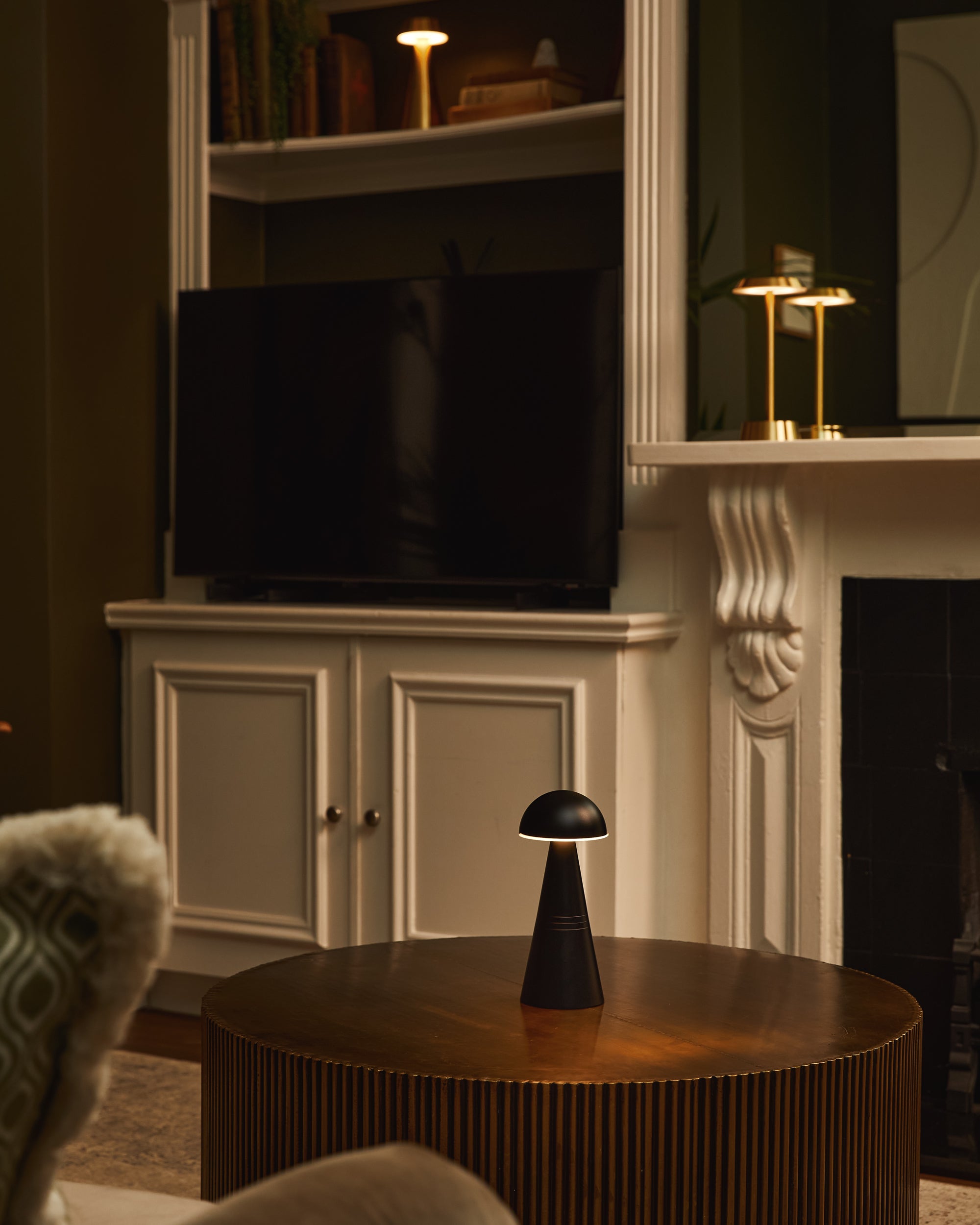 Living room with a television, cabinet, and cordless table lamps.