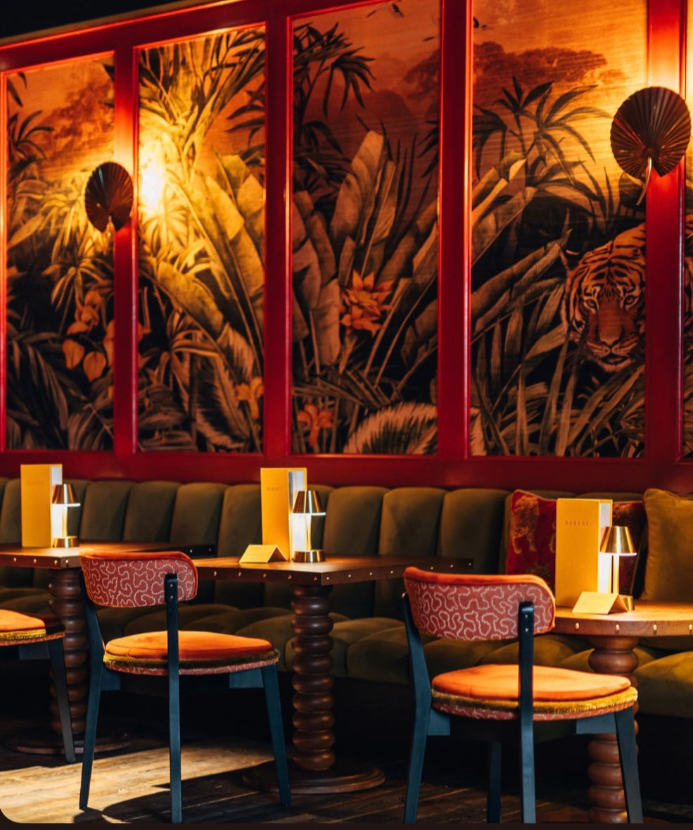 Decorative wall with animal-themed artwork in a cozy restaurant setting.