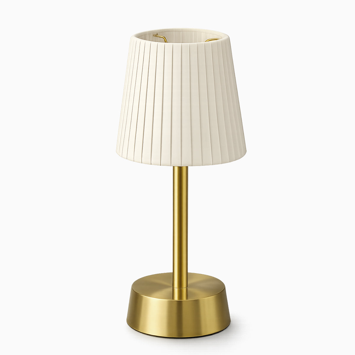 Cordless table lamp with ivory pleated shade and brass base on a white background