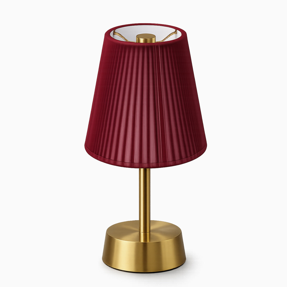 Cordless table lamp with a red cotton shade and brass base on a white background