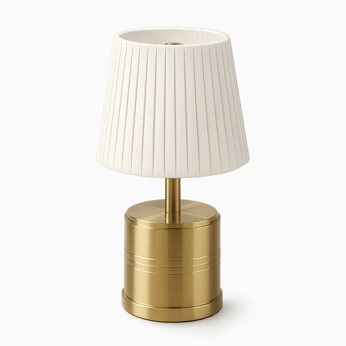 Cordless table lamp with a ivory pleated shade and brass base on a white background