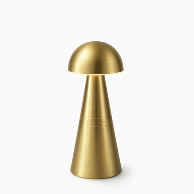 Brass cordless table lamp on a white background