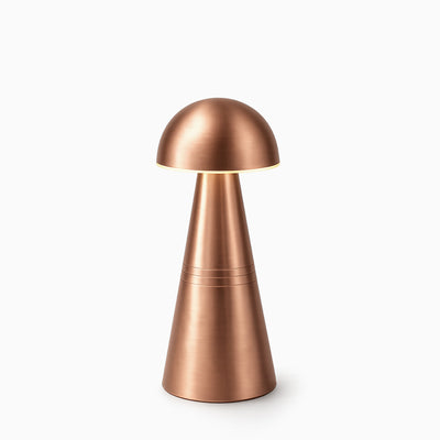 Copper cordless table lamp on a white background