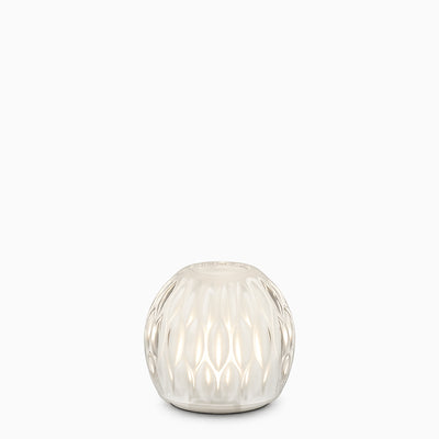 Decorative glass cordless lamp with textured surface on a white background