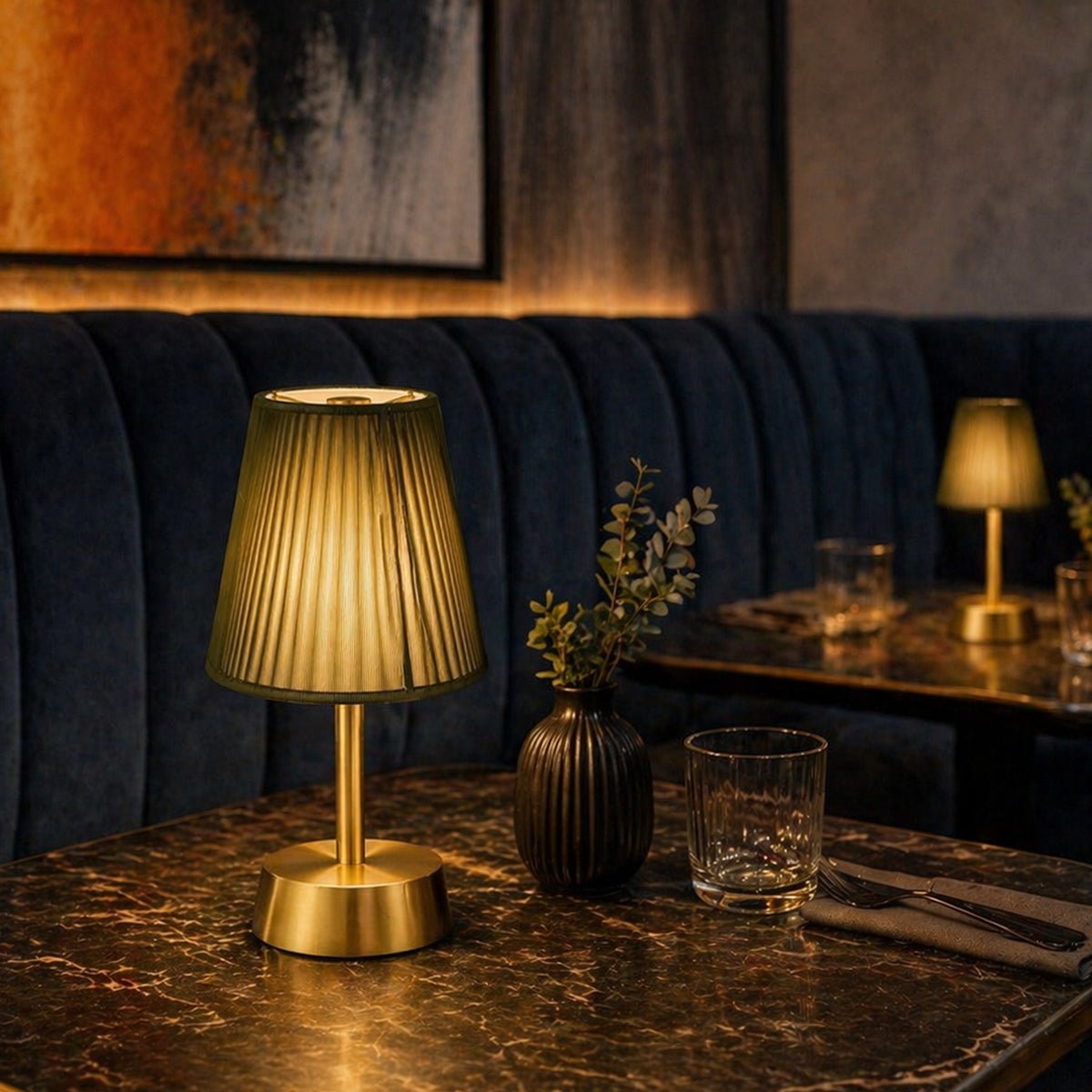 Decorative rechargeable table lamp on a marble table with a cozy restaurant interior setting.