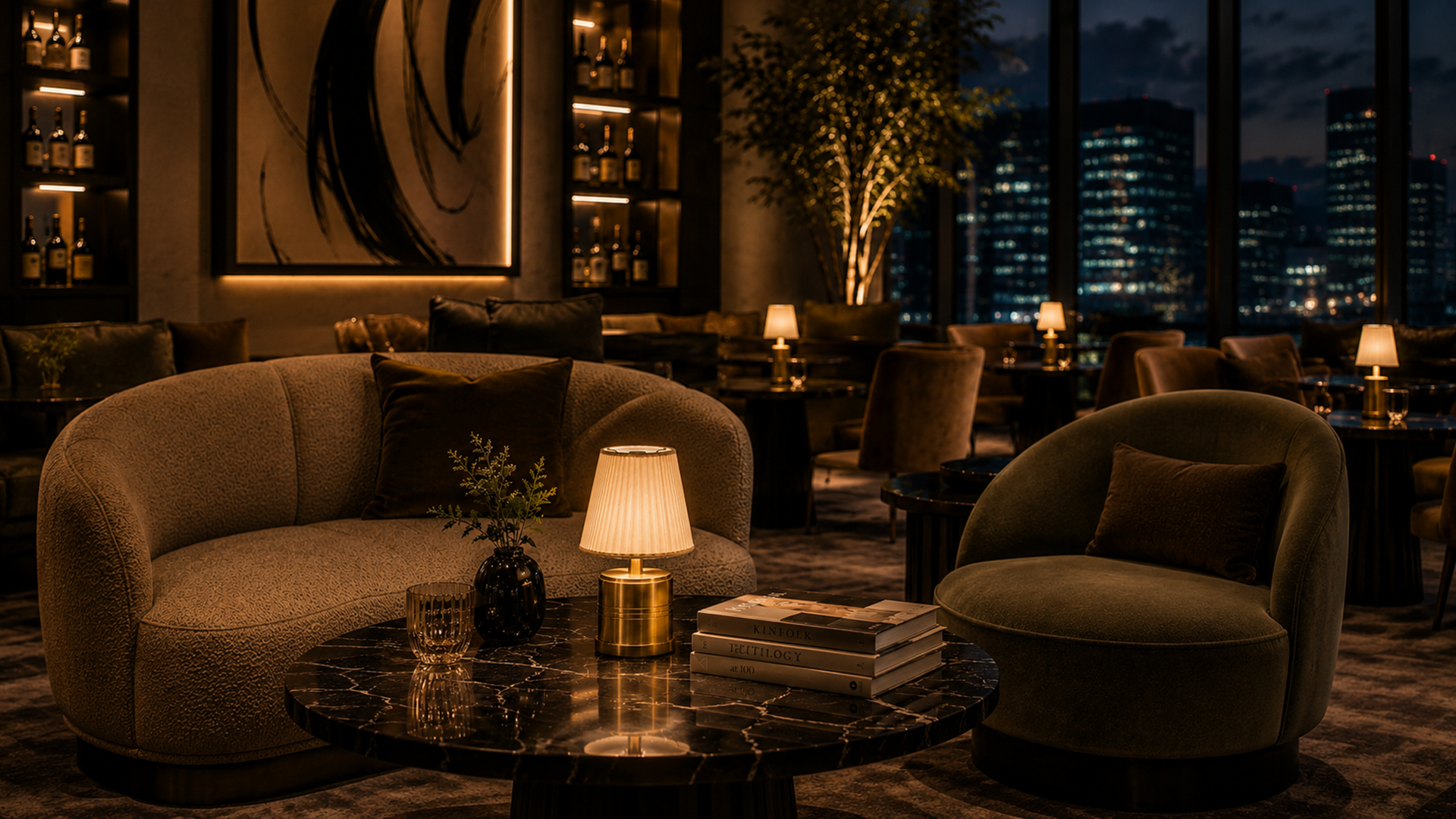 Luxury lounge with plush seating and a rechargeable table lamp in a high-rise setting at night.