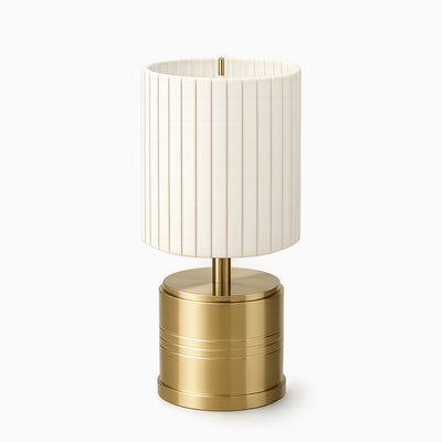 Cordless table lamp with a ivory cotton shade and brass base on a white background