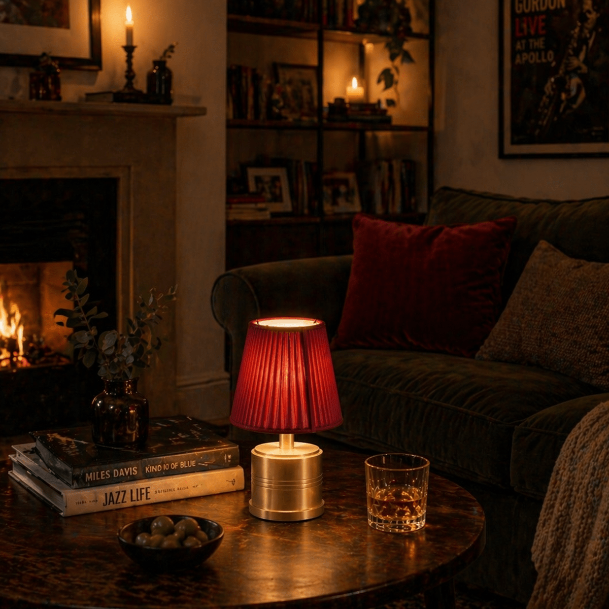 Cozy living room with a lit fireplace, rechargeable lamp, and books on a table.