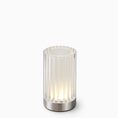 Modern cordless table lamp with ribbed glass shade on a white background