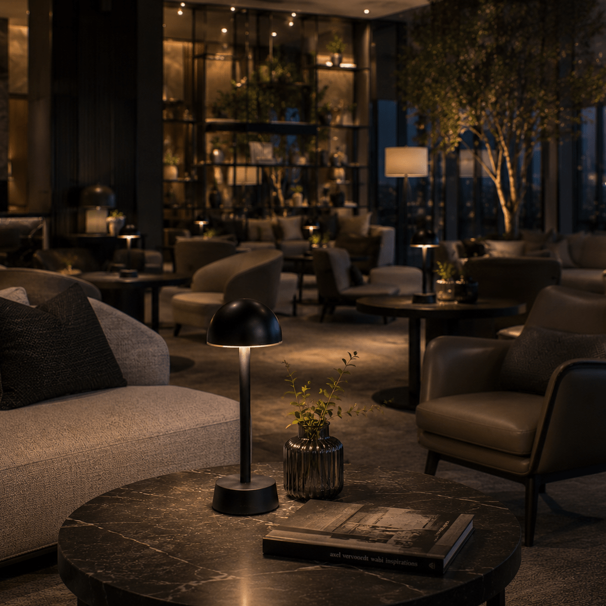 Modern lounge area with rechargeable table lamps, furniture, and decor.