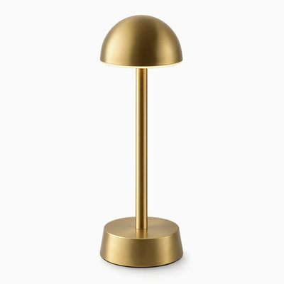 Brass cordless table lamp on a white background