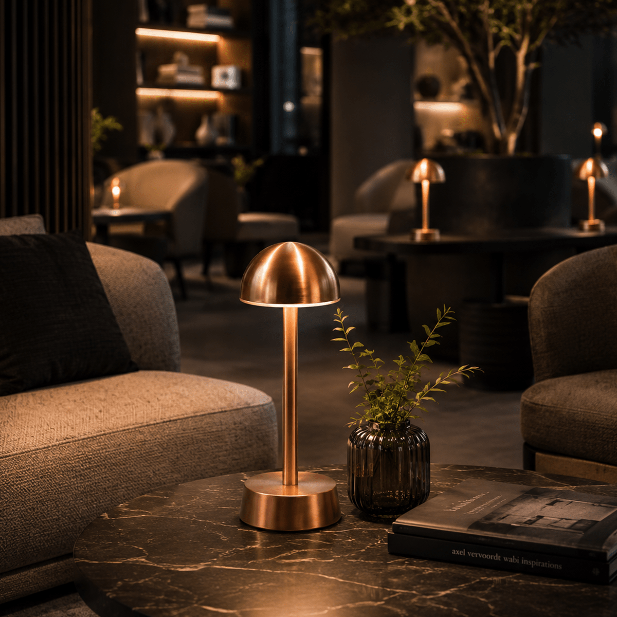 Copper rechargeable table lamp on a marble surface with a cozy indoor setting.