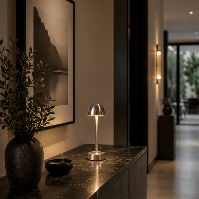 Modern rechargeable table lamp on a dark console table with decorative elements in a home setting