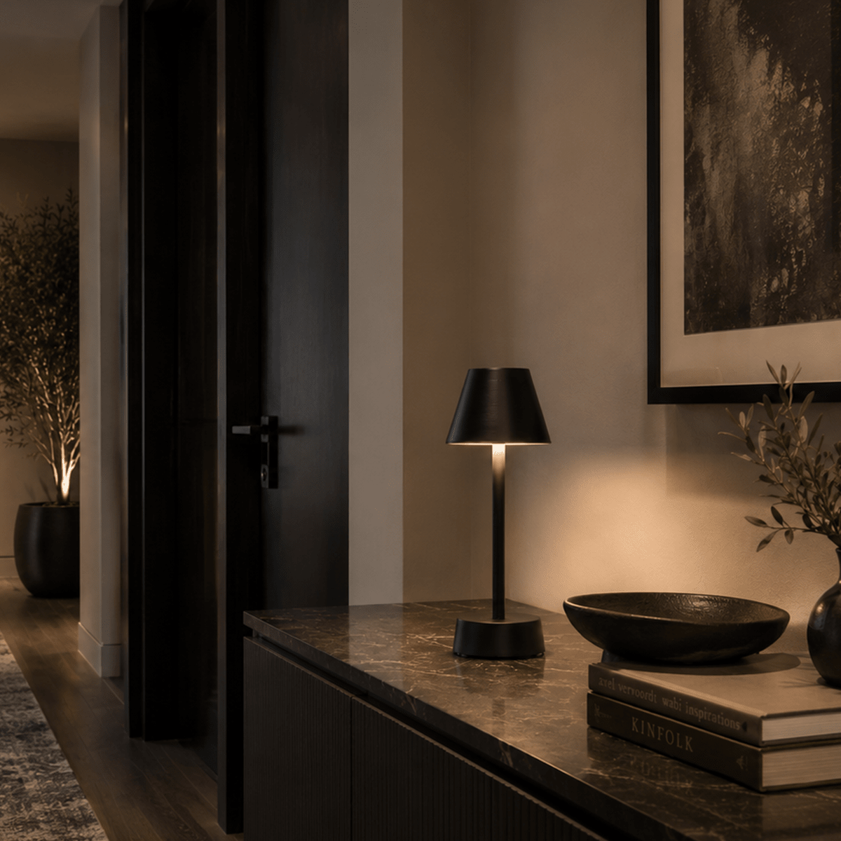 Modern black rechargeable table lamp on a dark surface with a neutral background