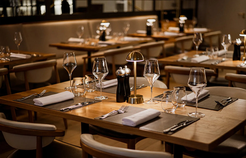 Cordless table lamp with a dome shade in the middle of a restaurant table